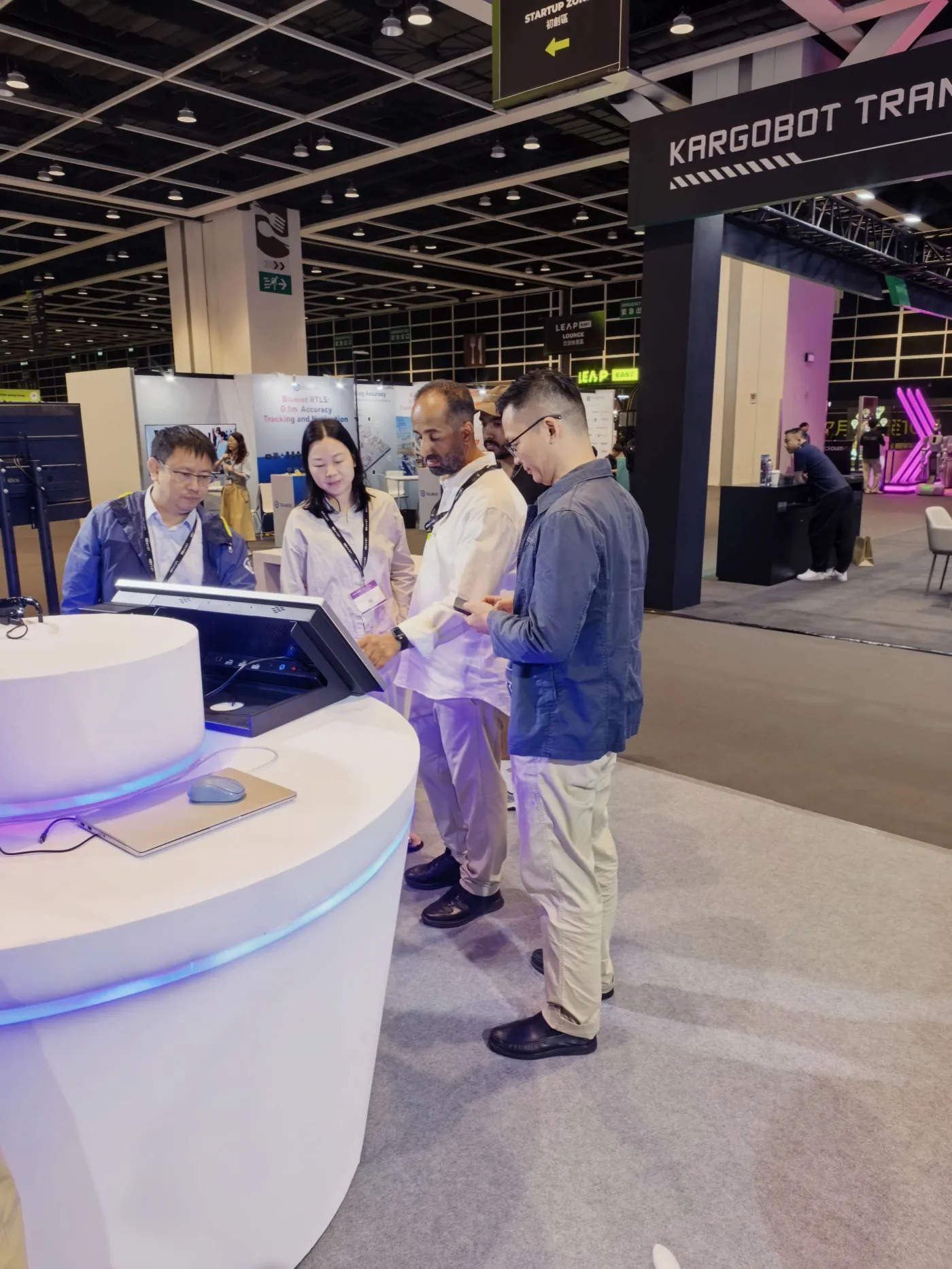 International visitors reviewing a service terminal demonstration